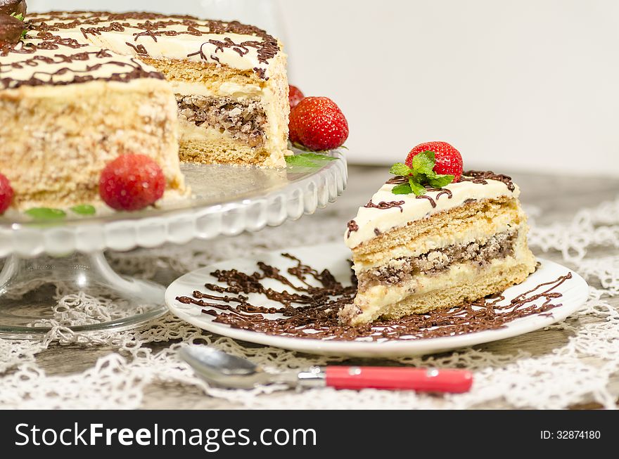 Homemade nutty cake with strawberries and slice of cake