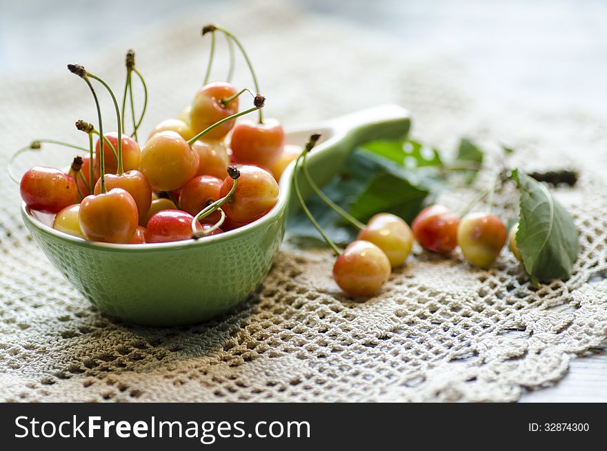 Ripe cherries in the cup on knitted tablecloth. Ripe cherries in the cup on knitted tablecloth