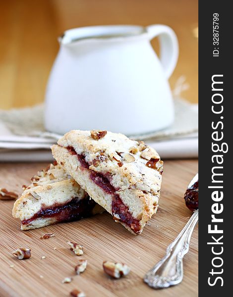 Raspberry pecan scones with creamer.