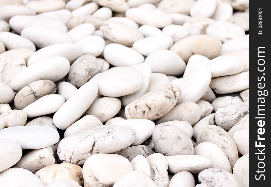 Sea stone naturally polished white rock pebbles background