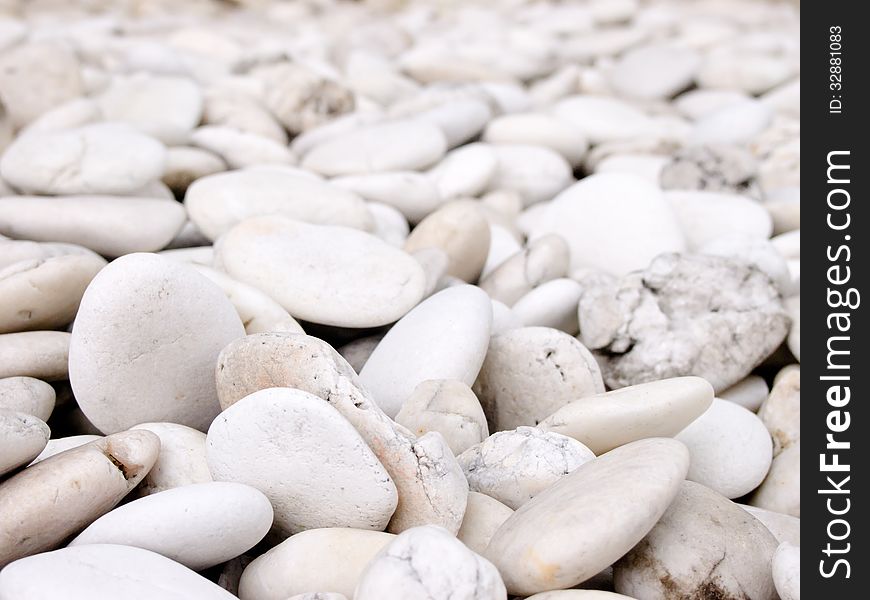 Sea stone naturally polished white rock pebbles background