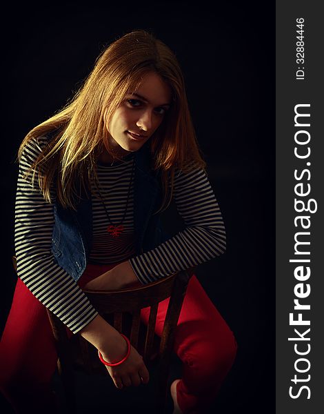 Portrait of beautiful thoughtful girl close up in the dark