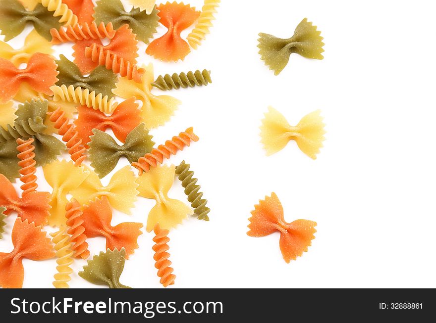 Different pasta in three colors on a white background