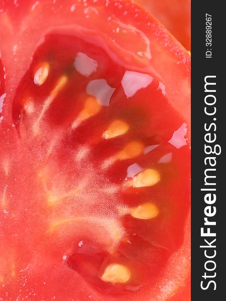 Half slice of tomato close up isolated on the white background