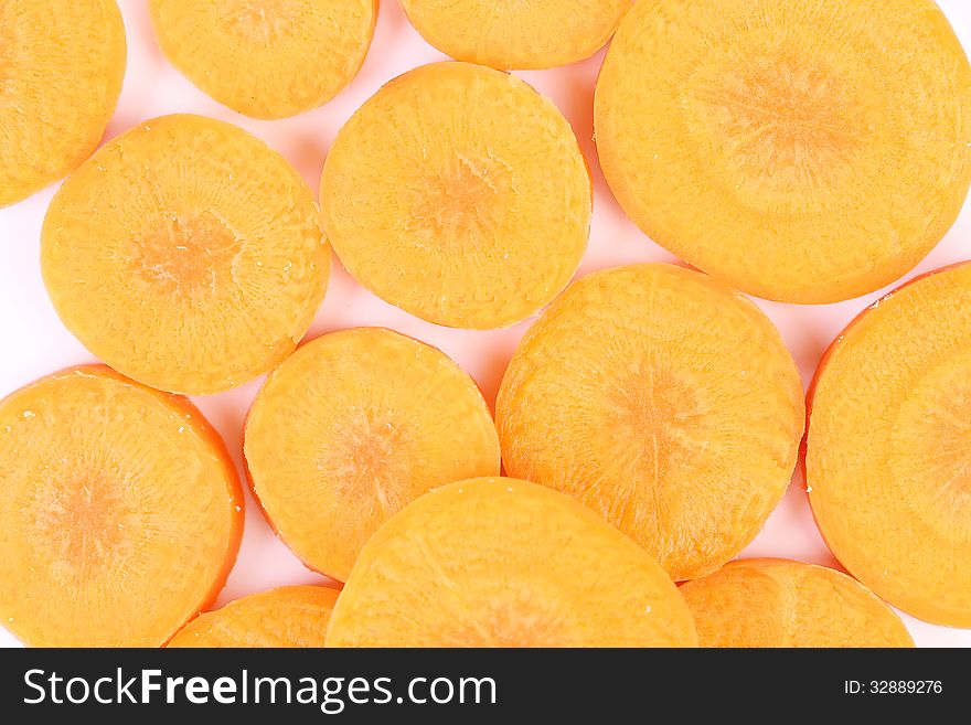Raw Carrot Slices On A Whole Background