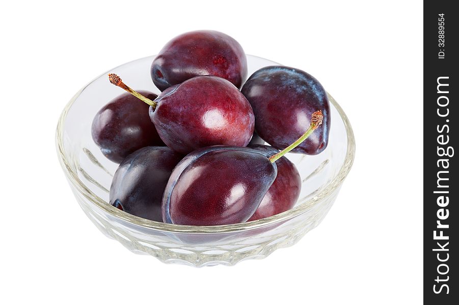 Ripe plums in a crystal dish isolated on white background. Ripe plums in a crystal dish isolated on white background