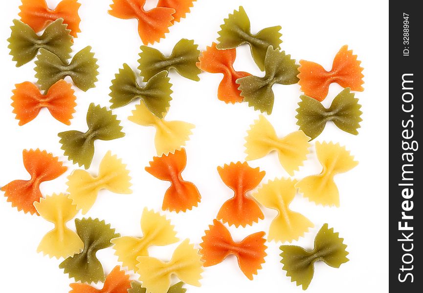 Background of the farfalle pasta three colors. Close up.
