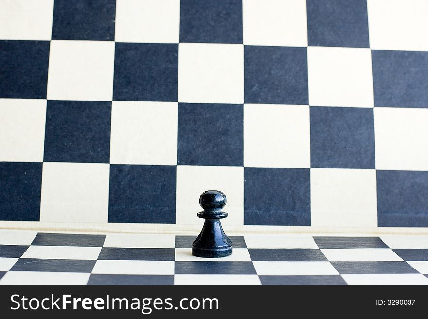 Little pawn on chessboard background