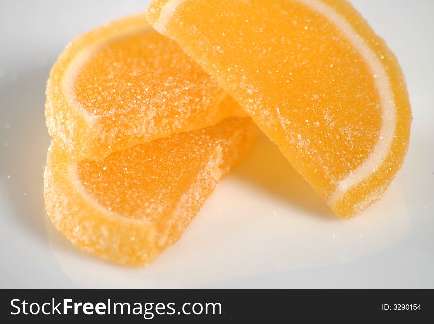 Orange slice sugar coated gummy candy close up. Orange slice sugar coated gummy candy close up