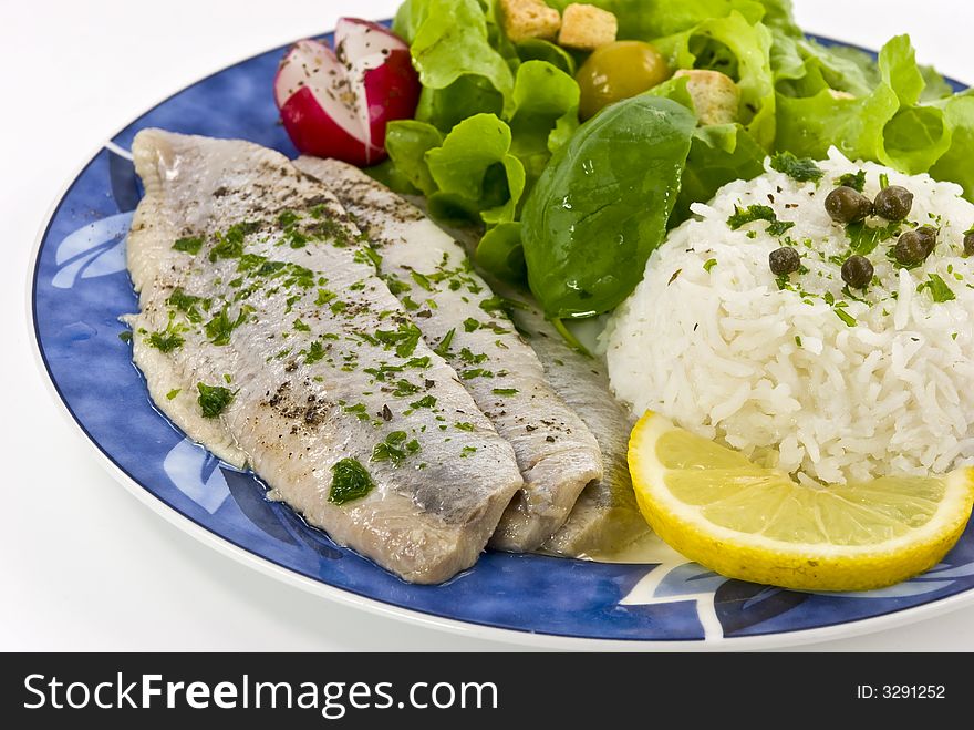 Gourmet young herring fillets with salad.