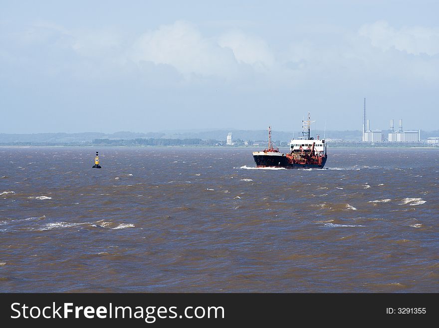 A dredger steaming out to clear the shipping lanes. A dredger steaming out to clear the shipping lanes