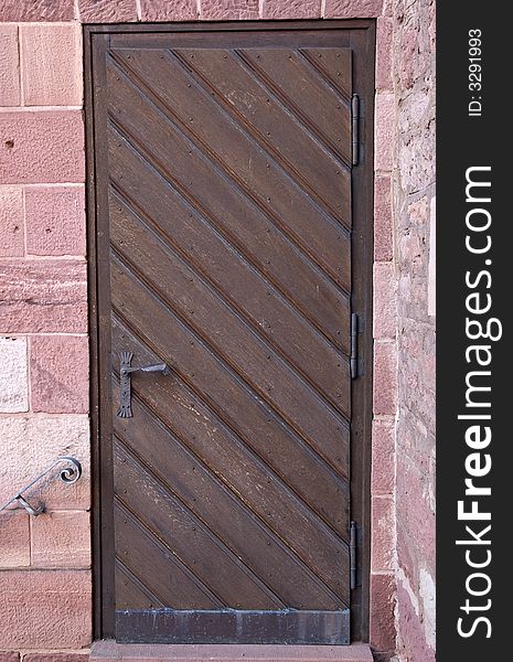 Old closed wooden door in a brick wall. Old closed wooden door in a brick wall