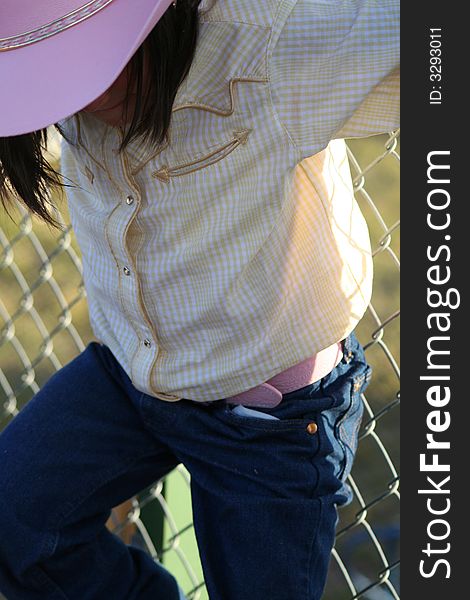 Smiling girl hanging out by the fence