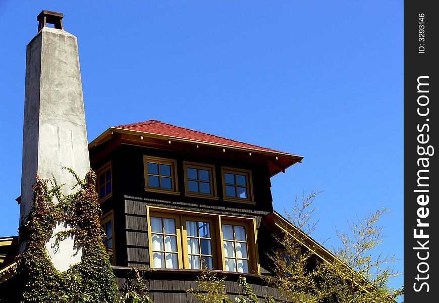 A shot of the top of a house with a chimney. A shot of the top of a house with a chimney.