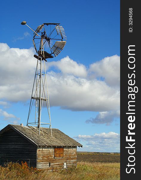 A windmill is built into an old shed or granary on a remote farm in northern Canada. A windmill is built into an old shed or granary on a remote farm in northern Canada