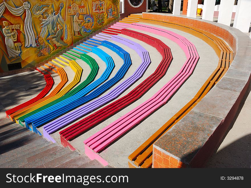 Rainbow colored benches at childpark