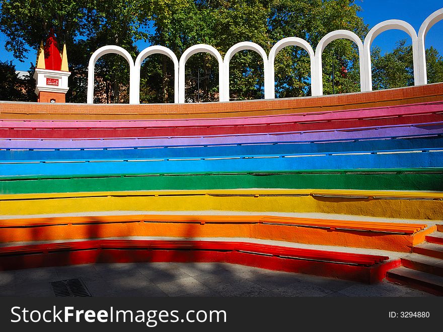 Rainbow colored benches in opened theatre