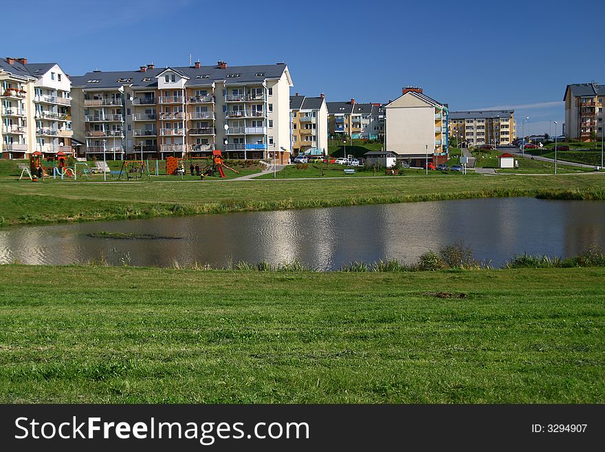 City scene, rest time... pond, grass, building