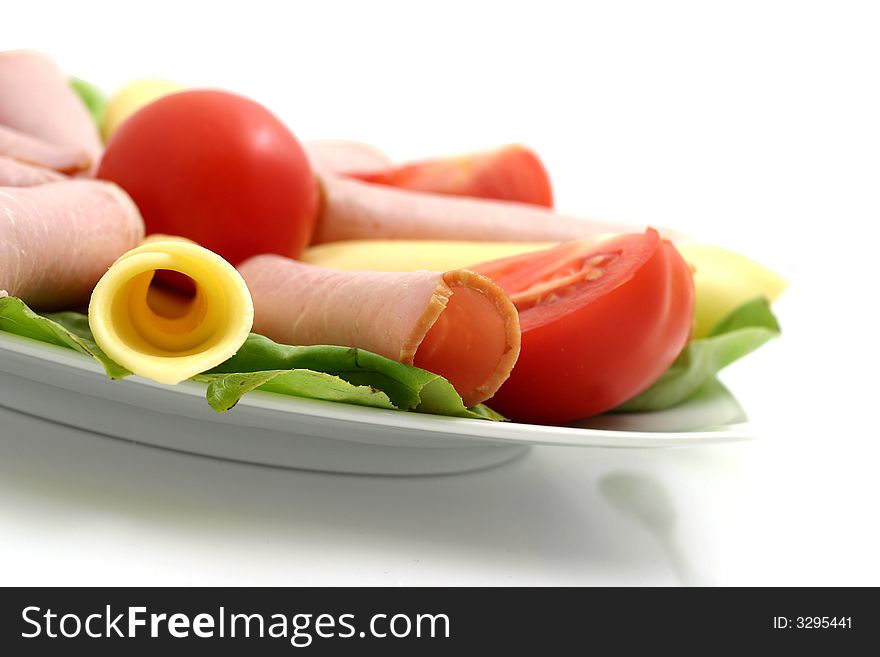 Plate of cheese, pork and tomatos