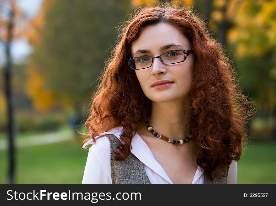 Redhair businesswoman portrait in park