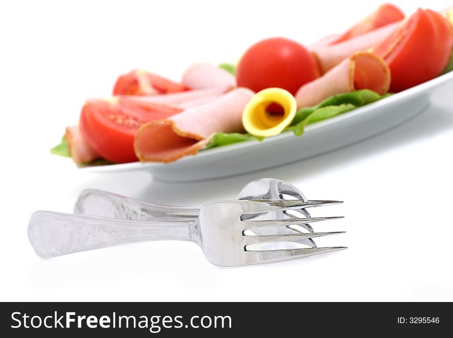 Plate of cheese, pork and tomatos