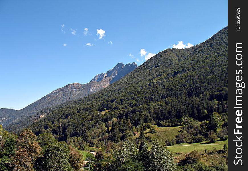 A mountain landscape in Valle Vigezzo, Italy,  wood and peaks at the beginning of fall season