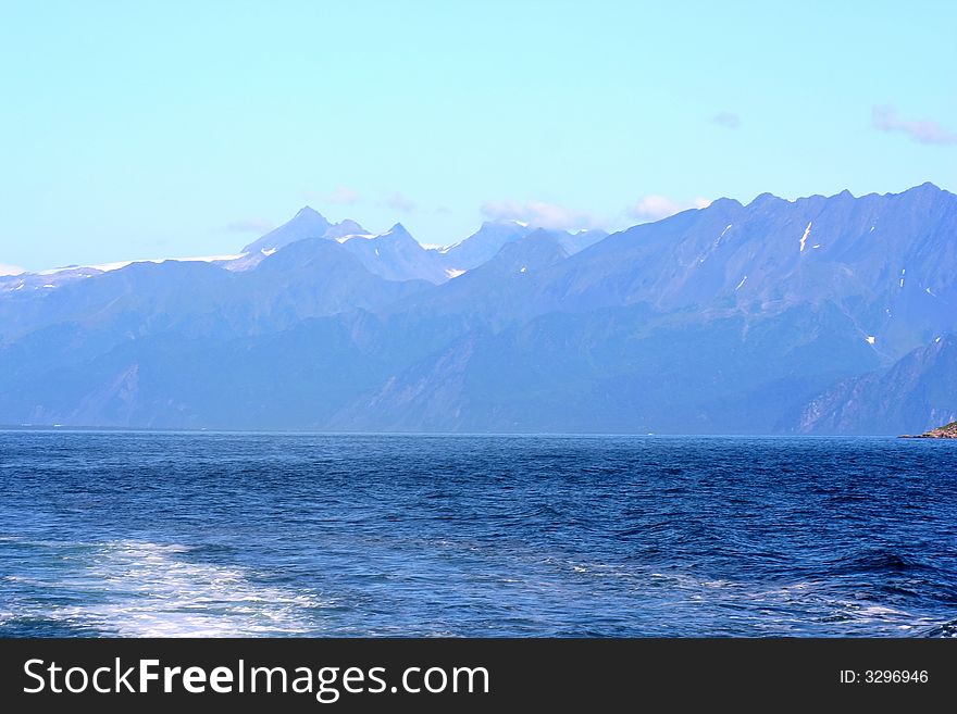 Alaska shorline with snow-covered mountains in background. Alaska shorline with snow-covered mountains in background.