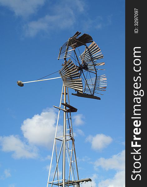 An old broken windmill sits in the fall breeze, umoving. An old broken windmill sits in the fall breeze, umoving.