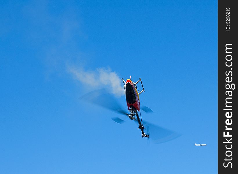 An model helicopter flying upside down. An model helicopter flying upside down