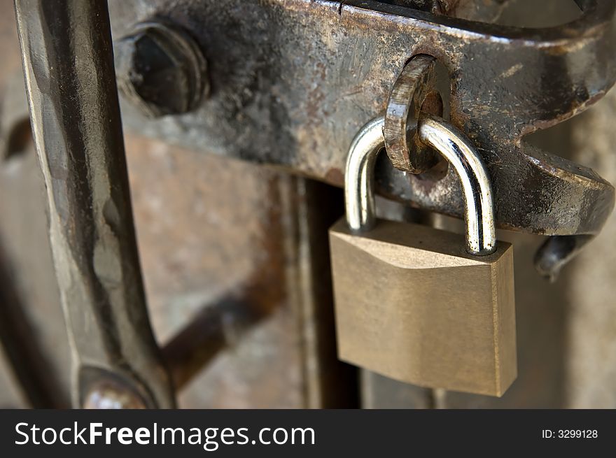 Padlock on a rusty metal door