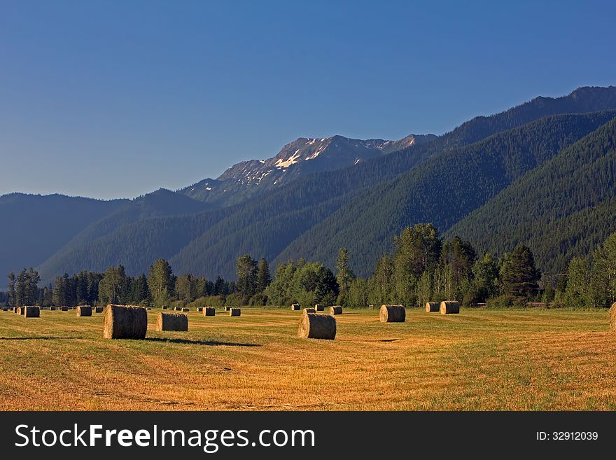 This image of the hay bales and the rugged mountains in the background was taken in the early morning light in the Nyack area of NW Montana. This image of the hay bales and the rugged mountains in the background was taken in the early morning light in the Nyack area of NW Montana.