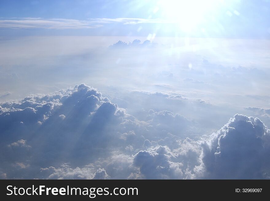 Air view near Mexico City. The magnificent clouds make some shadows mixing with the strong sunlight among the clouds. Air view near Mexico City. The magnificent clouds make some shadows mixing with the strong sunlight among the clouds.