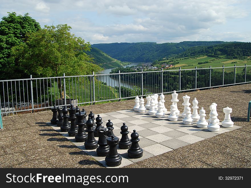 Outdoor chessboard at Marienburg Mosel Germany with vineyards beyond