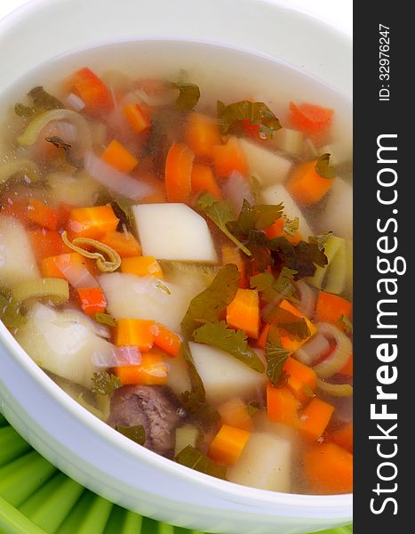 Simple Vegetable Soup with Potato, Carrot, Leek and Greens in Bowl closeup