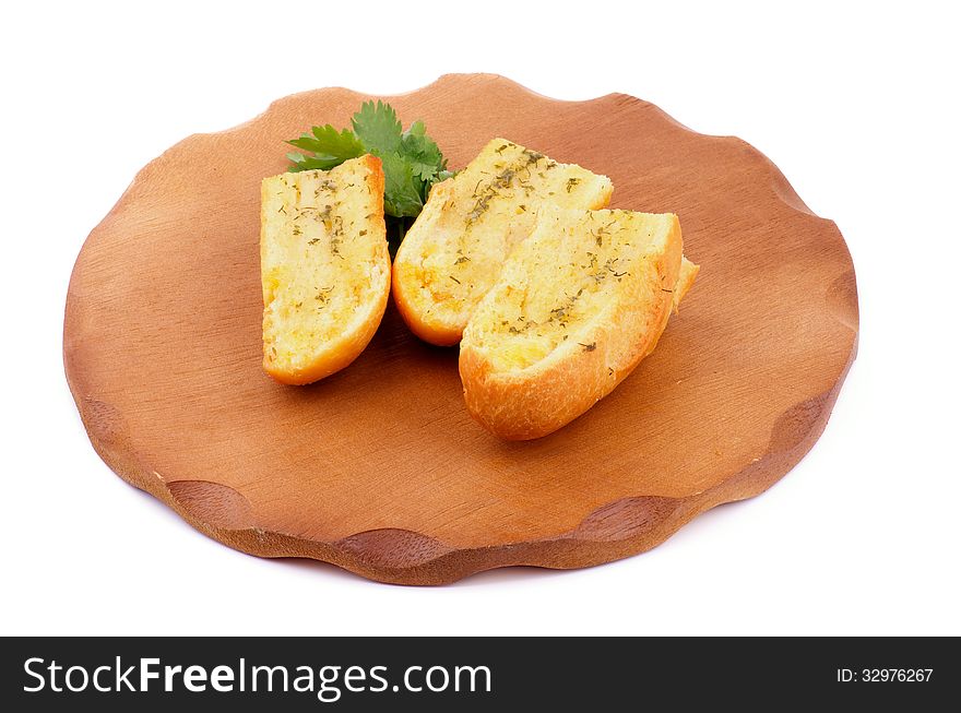 Arrangement of Three Slices of Garlic and Herb Bread on Wooden Cutting Board isolated on white background