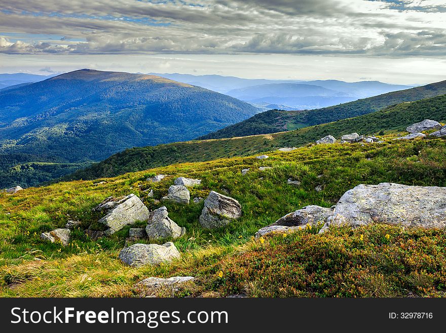 Hilly slopes of high mountains strewn with large stones. Hilly slopes of high mountains strewn with large stones