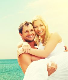 Happy Family Couple In Love Hugging And Laughing On The Beach Stock Photo Happy Family Couple In Love Hugging And Laughing On The Beach Stock Photo