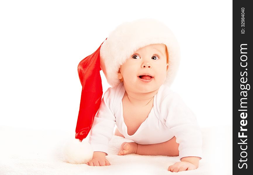 Beautiful baby in a Christmas hat isolated on white