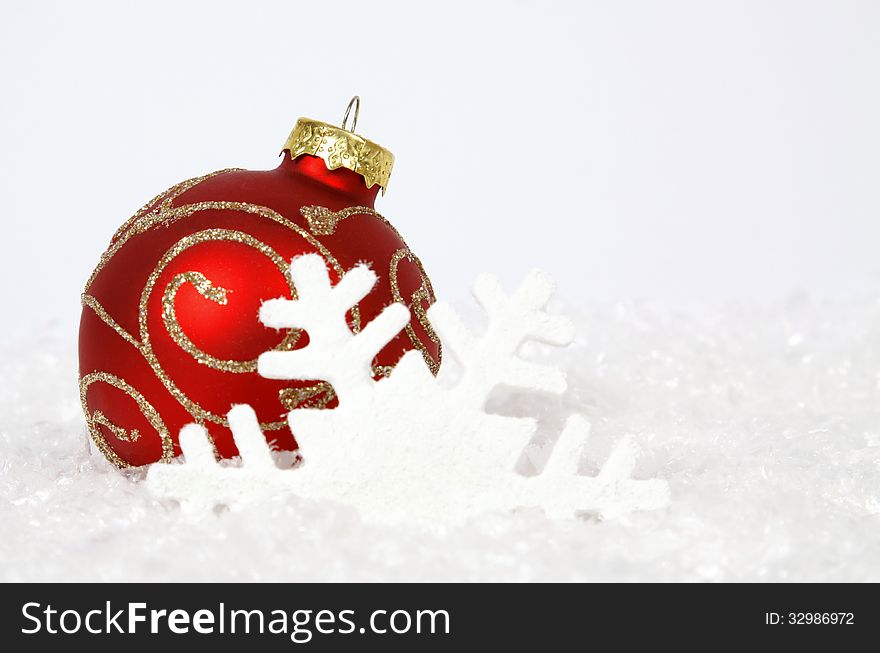 Red-golden bauble on the white background. Red-golden bauble on the white background