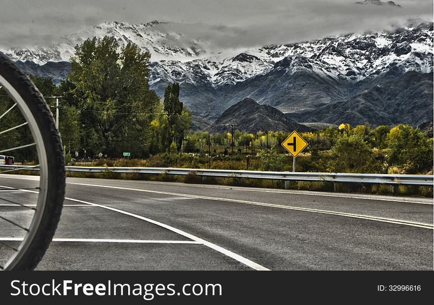 Beautiful mountain landscape, where you can see the imposing Andes Mountains with snowy peaks, on a cloudy day, with the green landscape of southern Mendoza, Argentina, an area with its charms for bike rides, through the vineyards and tourism wineries call Tunuyan. Beautiful mountain landscape, where you can see the imposing Andes Mountains with snowy peaks, on a cloudy day, with the green landscape of southern Mendoza, Argentina, an area with its charms for bike rides, through the vineyards and tourism wineries call Tunuyan