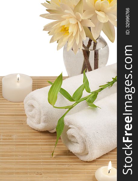 Two white towels, bamboo plant and fresh lotuses on bamboo mat. Two white towels, bamboo plant and fresh lotuses on bamboo mat.