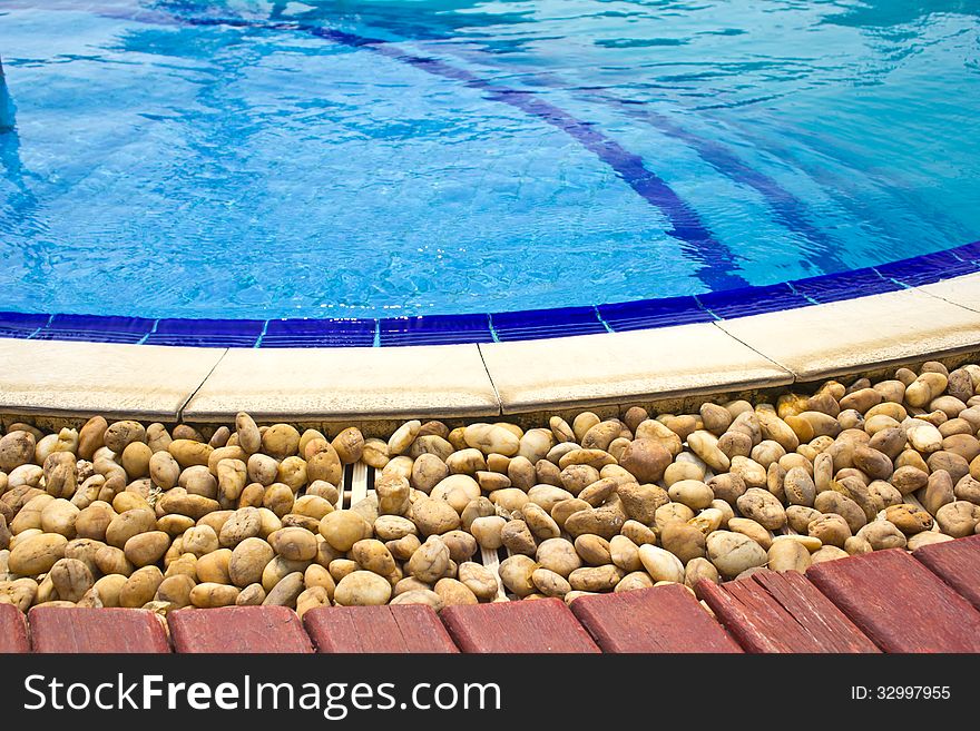 Luxury Resort Swimming Pool low angle on curved edge of a luxury resort swimming pool. Luxury Resort Swimming Pool low angle on curved edge of a luxury resort swimming pool