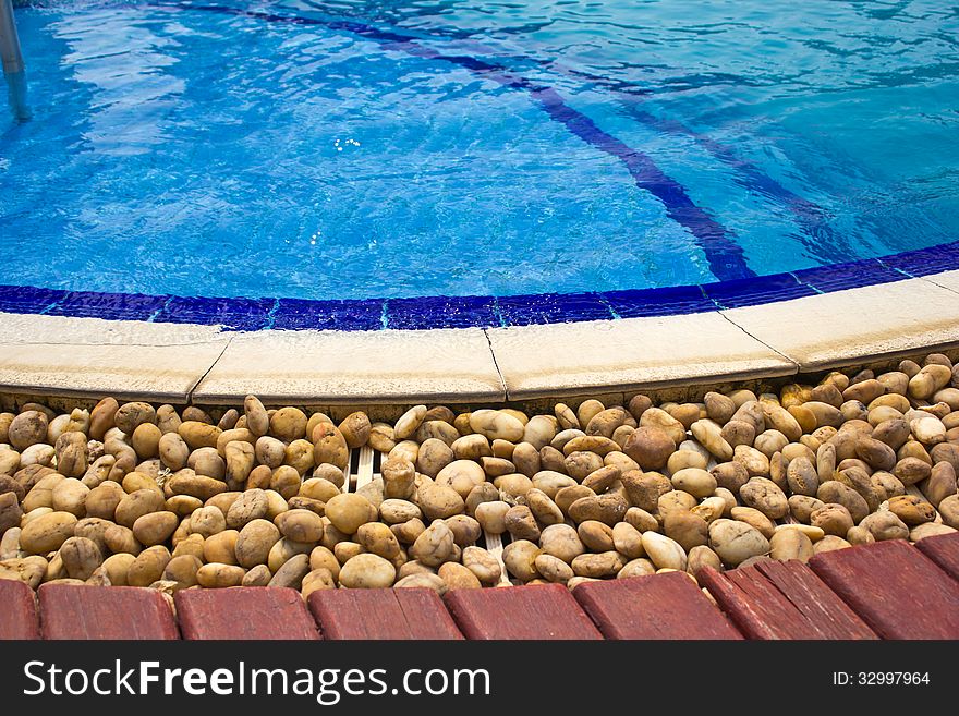 Luxury Resort Swimming Pool low angle on curved edge of a luxury resort swimming pool. Luxury Resort Swimming Pool low angle on curved edge of a luxury resort swimming pool