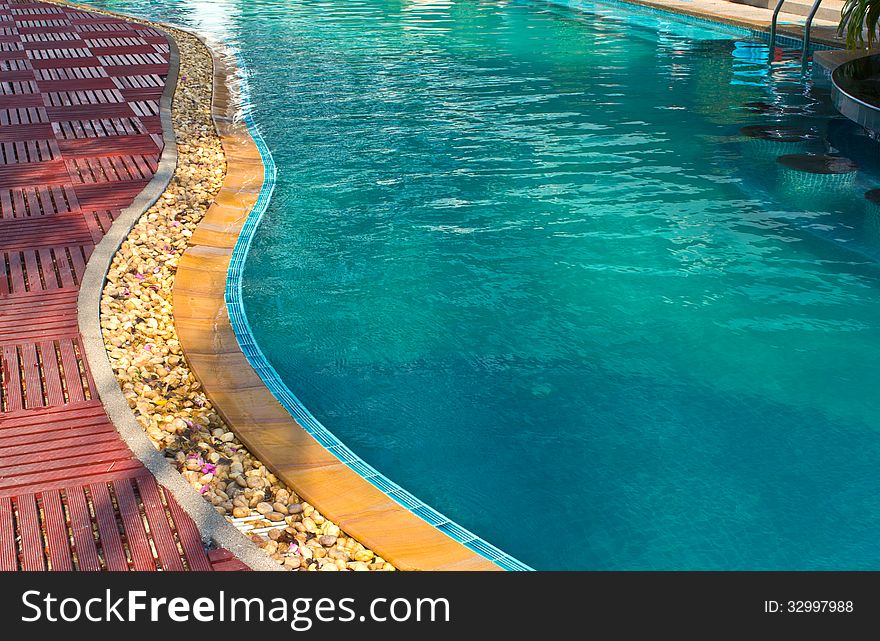 Luxury Resort Swimming Pool low angle on curved edge of a luxury resort swimming pool. Luxury Resort Swimming Pool low angle on curved edge of a luxury resort swimming pool