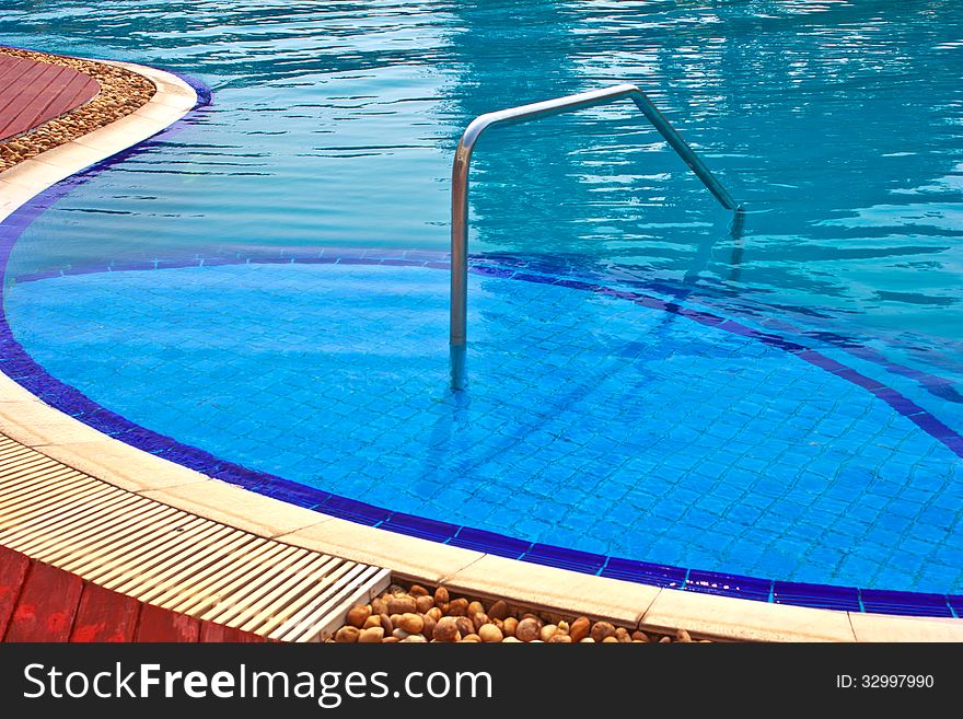 Luxury Resort Swimming Pool low angle on curved edge of a luxury resort swimming pool. Luxury Resort Swimming Pool low angle on curved edge of a luxury resort swimming pool