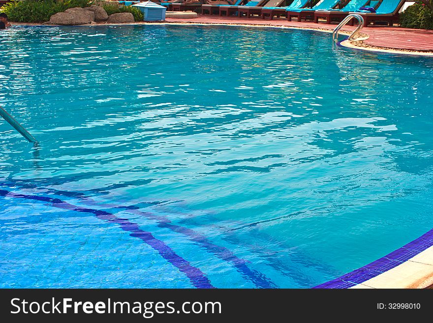 Luxury Resort Swimming Pool low angle on curved edge of a luxury resort swimming pool. Luxury Resort Swimming Pool low angle on curved edge of a luxury resort swimming pool