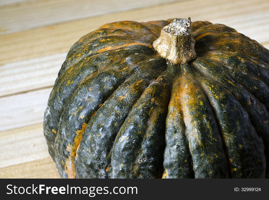 Pumpkin close up over wooden background with copy space