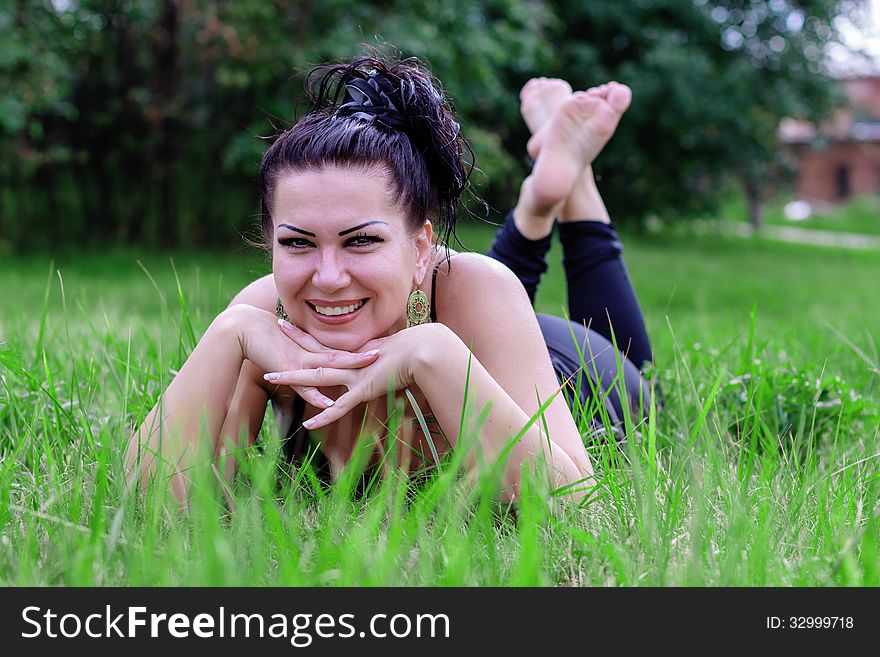 Brunette Smiling On A Grass