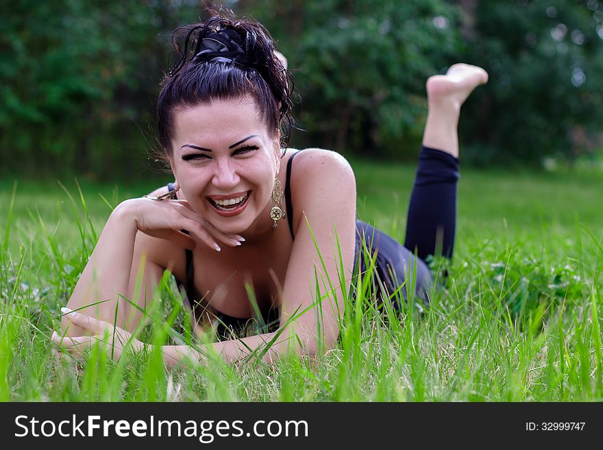 Brunette Laughing On A Grass