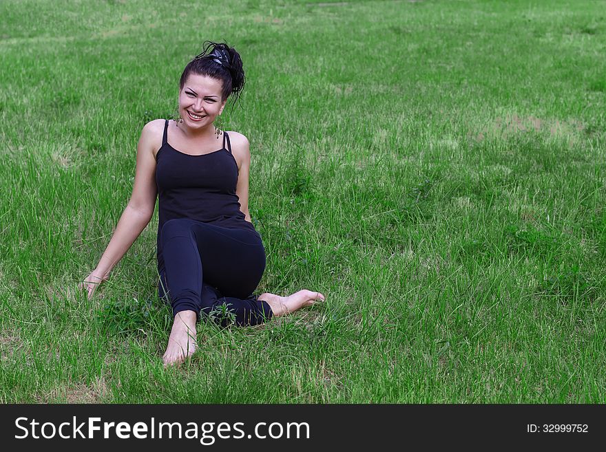 Brunette smiling on a grass